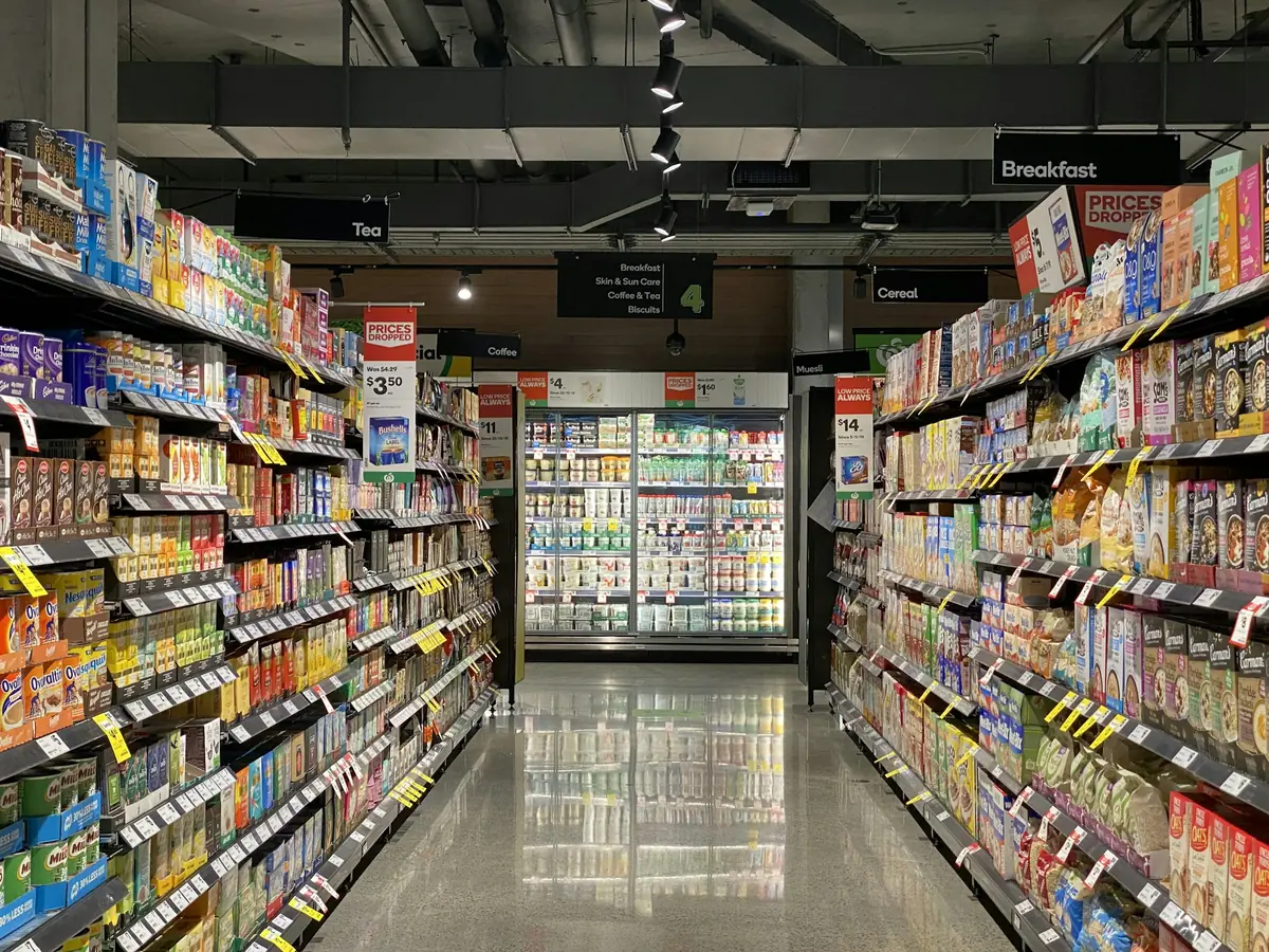 Supermarket aisle lined with packaged grocery products
