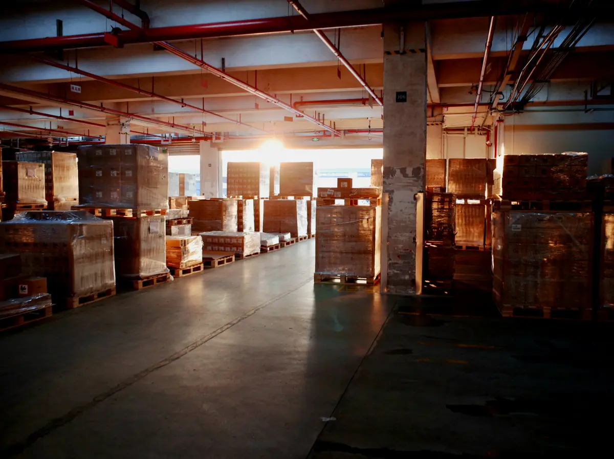 Pallets of stock in a warehouse at dusk