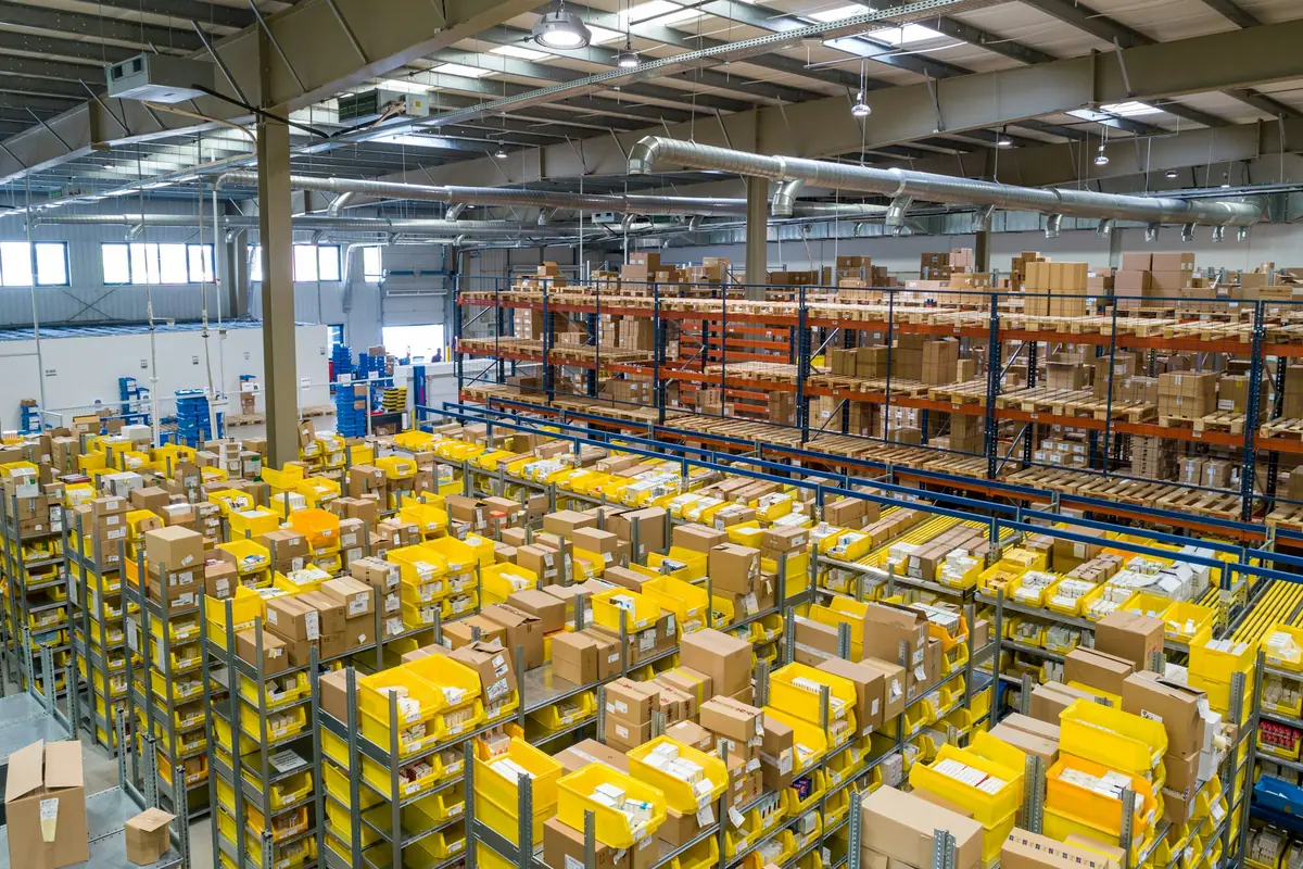 Wide view of a warehouse floor with pallets of stock