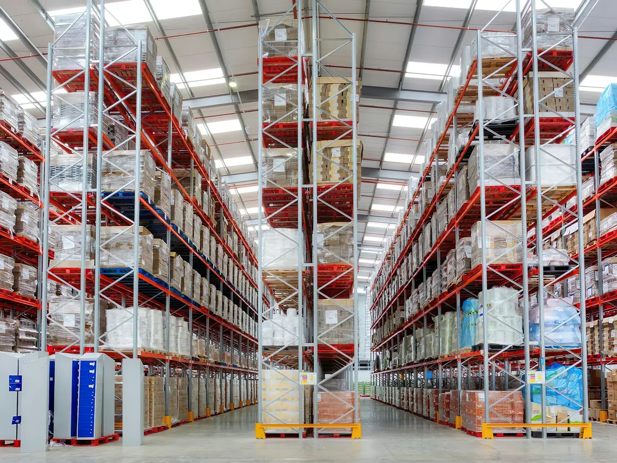 Tall warehouse racking stacked with pallets of cartons